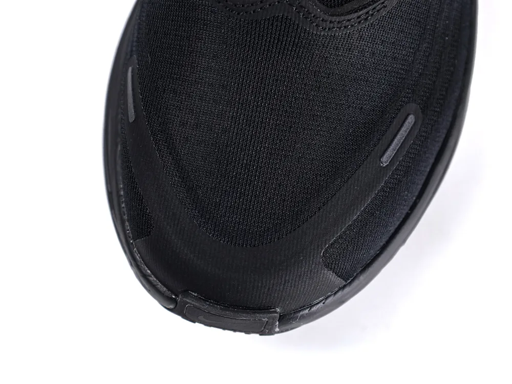 Close-up of a black fabric sneaker toe with rubber accents.
