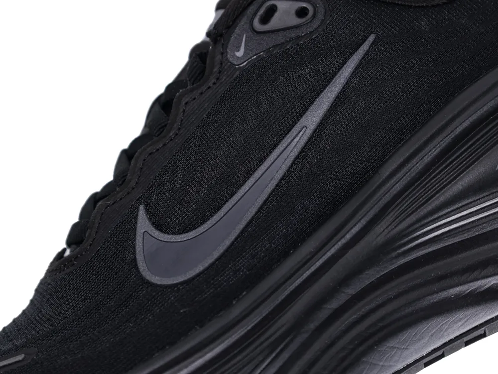 Black fabric sneaker with a sleek design and textured sole.