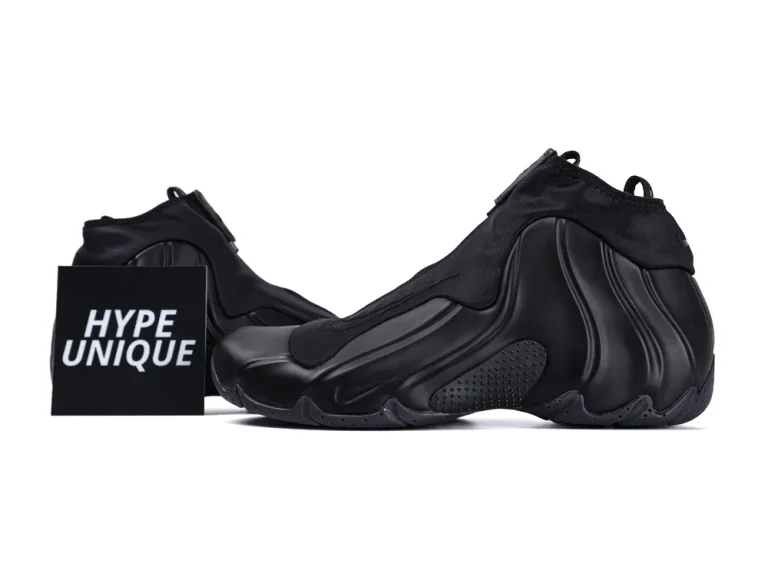 Black sneaker with a sleek design, featuring smooth synthetic material and textured sole.