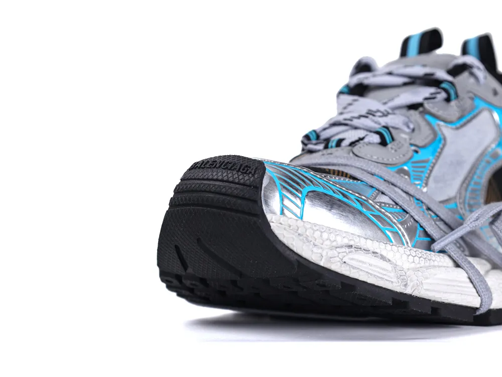 Silver and blue sneaker with black sole, featuring synthetic and rubber materials.