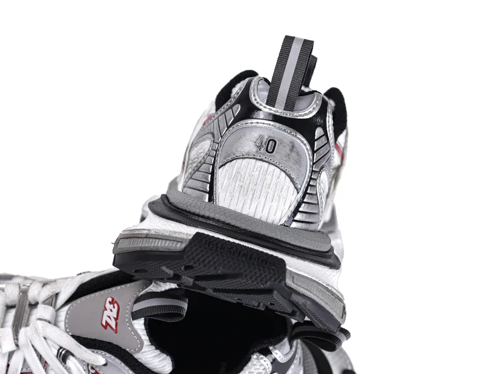 Silver and black sneakers with mesh and synthetic materials, featuring a textured sole.