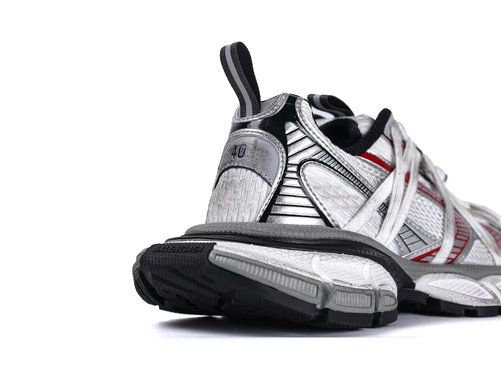 Rear view of silver mesh sneakers with black and red accents, rubber sole.