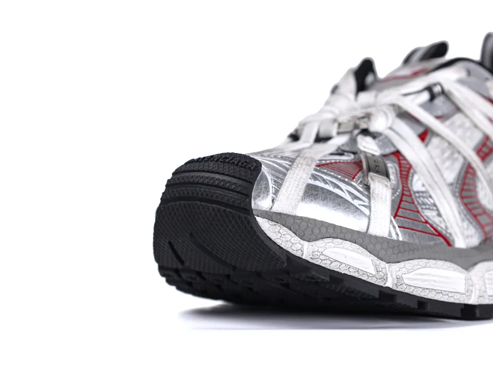 Silver and black sneaker with red accents and rubber sole, featuring white laces.