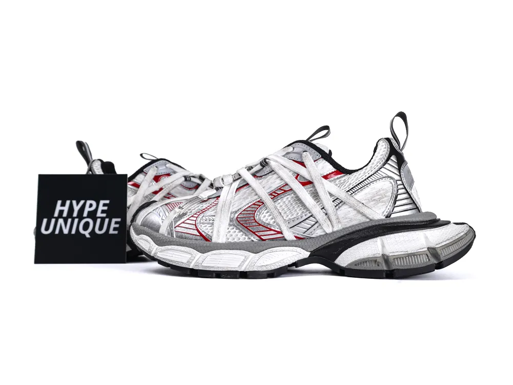 Silver and red sneakers with mesh uppers and sturdy black and white soles.