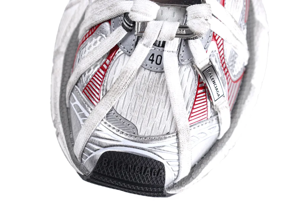 Silver and red sneaker, mesh material, featuring white laces and detailed stitching.