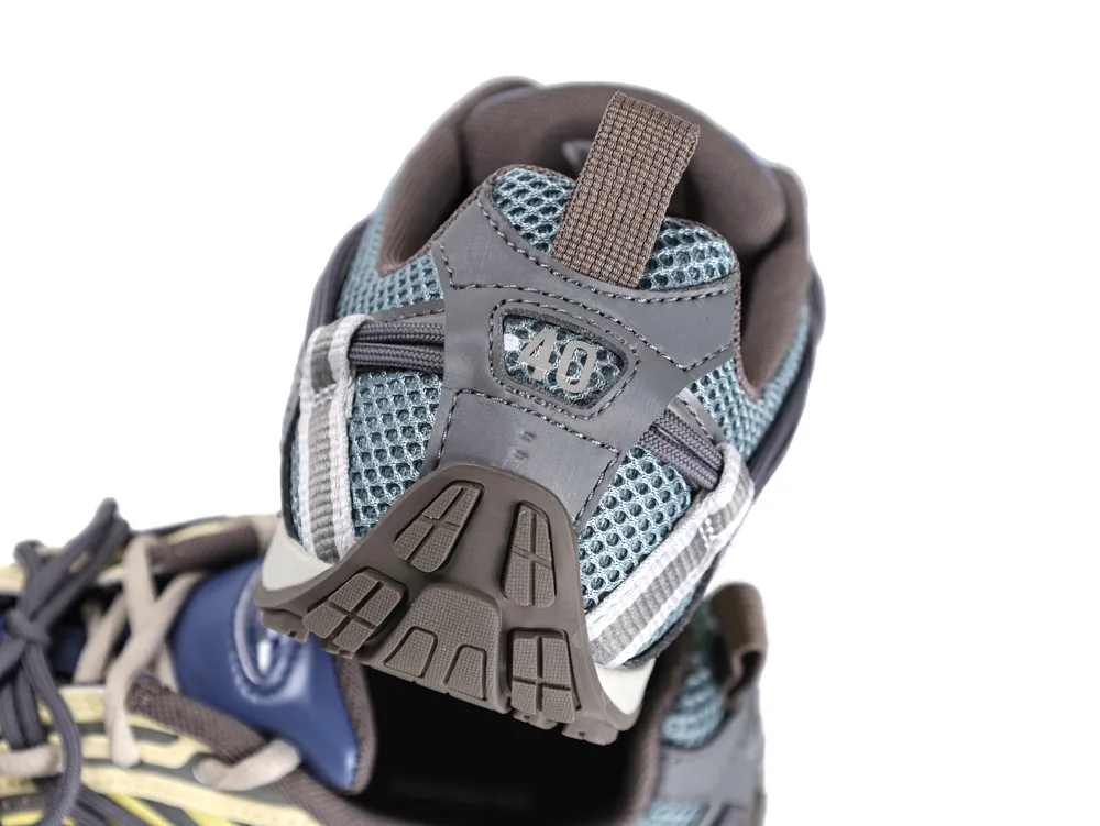 Gray and blue mesh sneaker heel with rubber sole and pull loop.