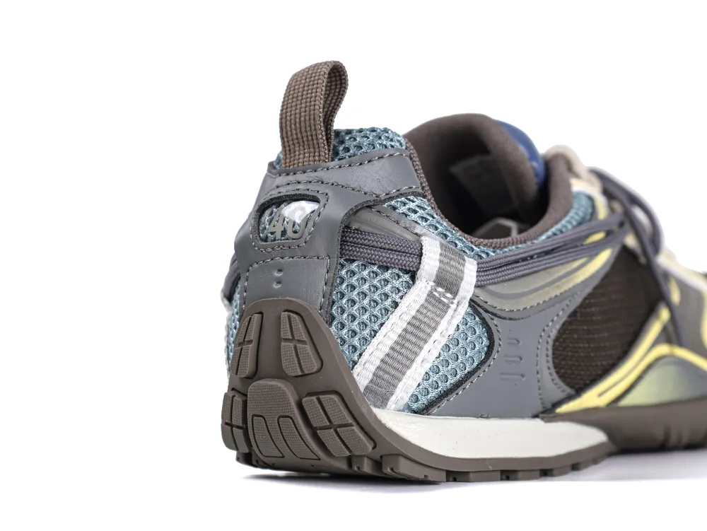 Close-up of a sneaker's heel, featuring gray leather and blue mesh materials.