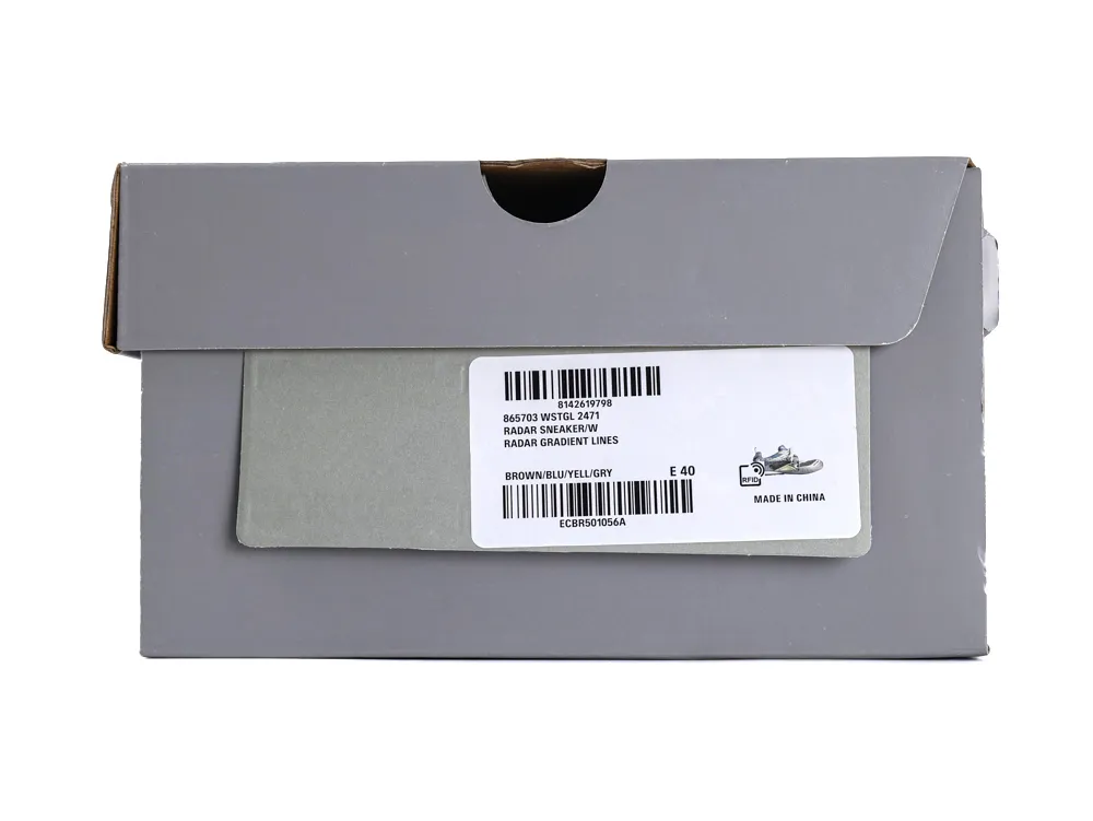 Gray cardboard shoebox with label, displaying brown, blue, yellow, gray sneaker description.