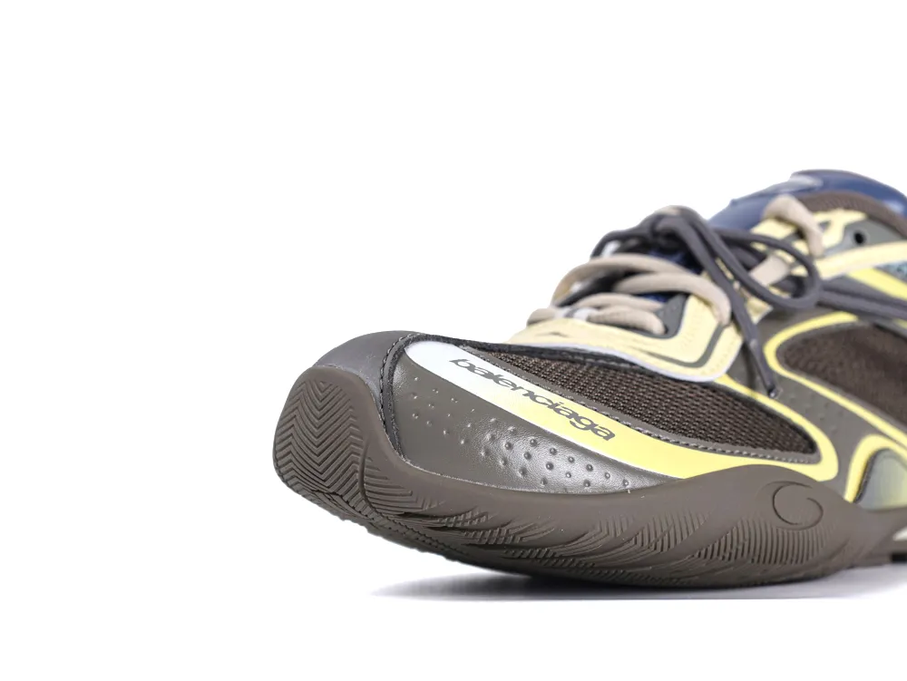 Brown and yellow sneaker with mesh and rubber materials on the toe section.