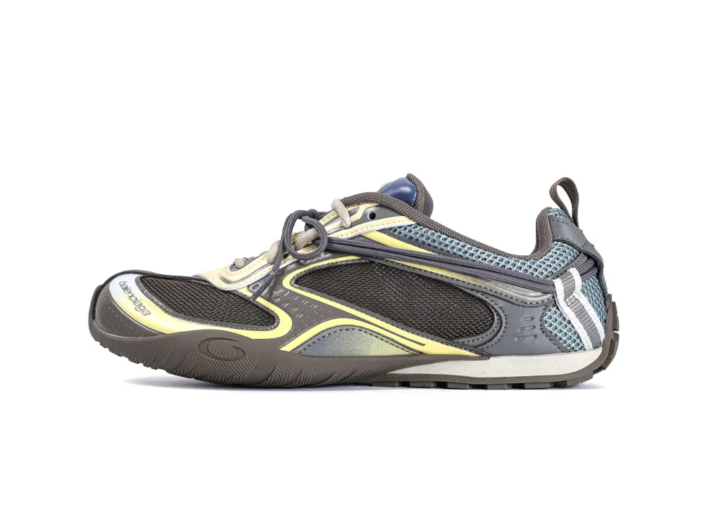 Gray, yellow, and black mesh sneaker with rubber sole and lace-up design.
