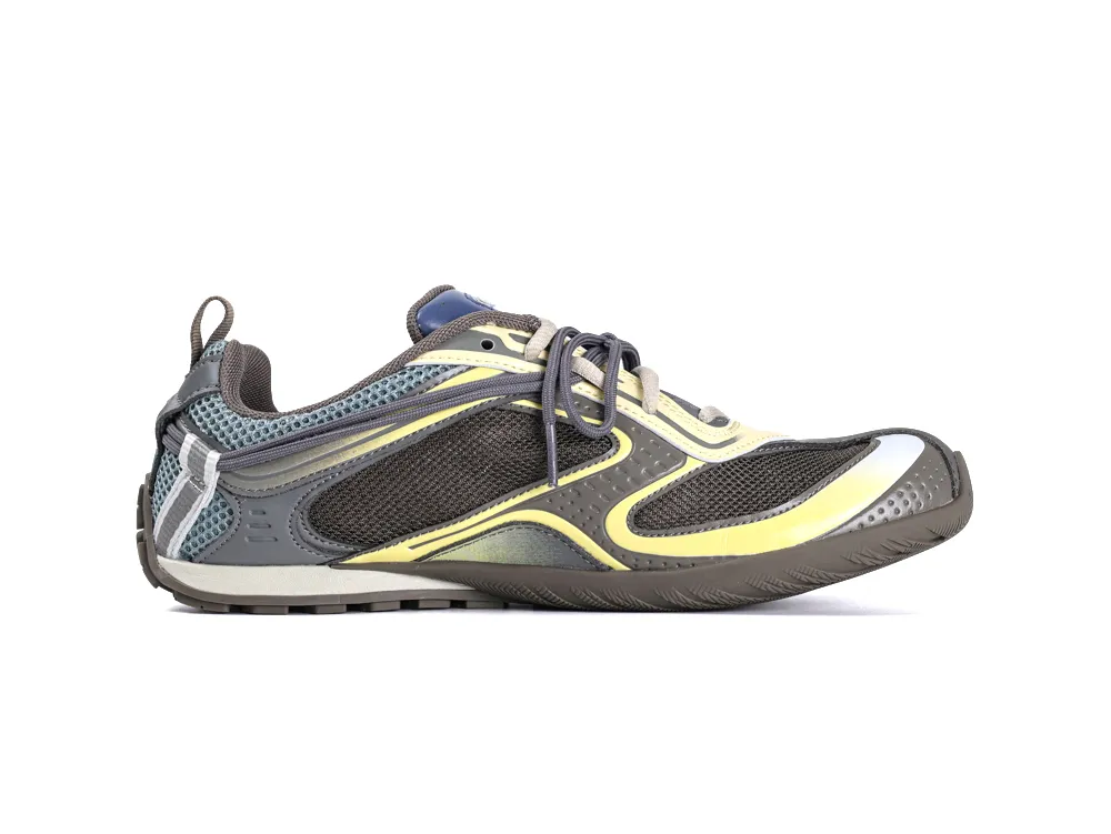 Gray and yellow sneaker with mesh panels, rubber sole, and lace-up closure.