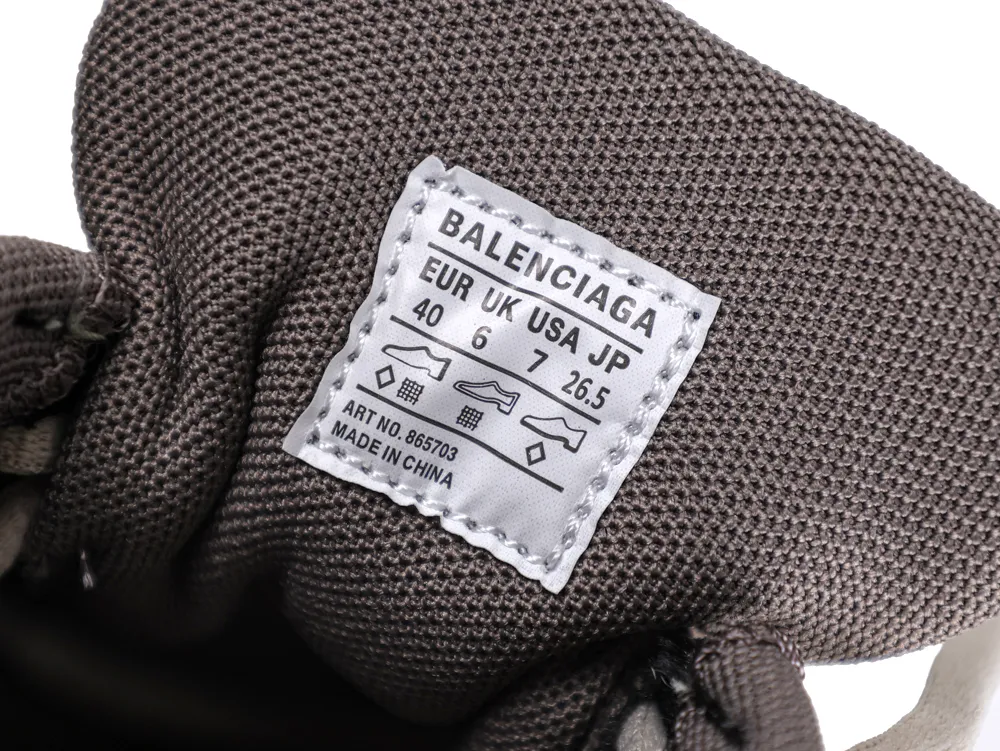 Close-up of a gray fabric shoe tongue with a white label.