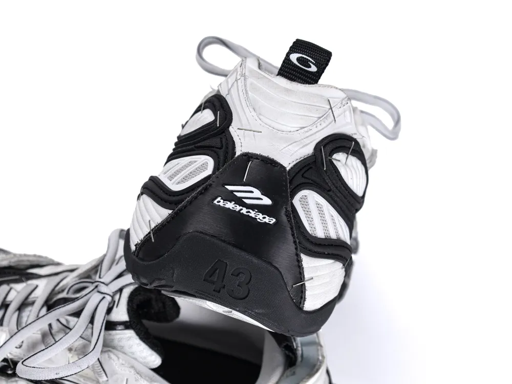 White and black sneaker with mesh material and rubber sole, featuring brand logo.