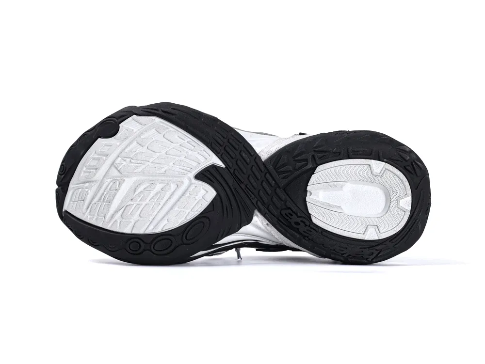 Black and white rubber sneaker sole with textured tread pattern.