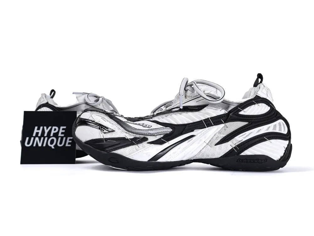 Black and white sneakers with mesh and synthetic material, featuring a distinctive layered design.