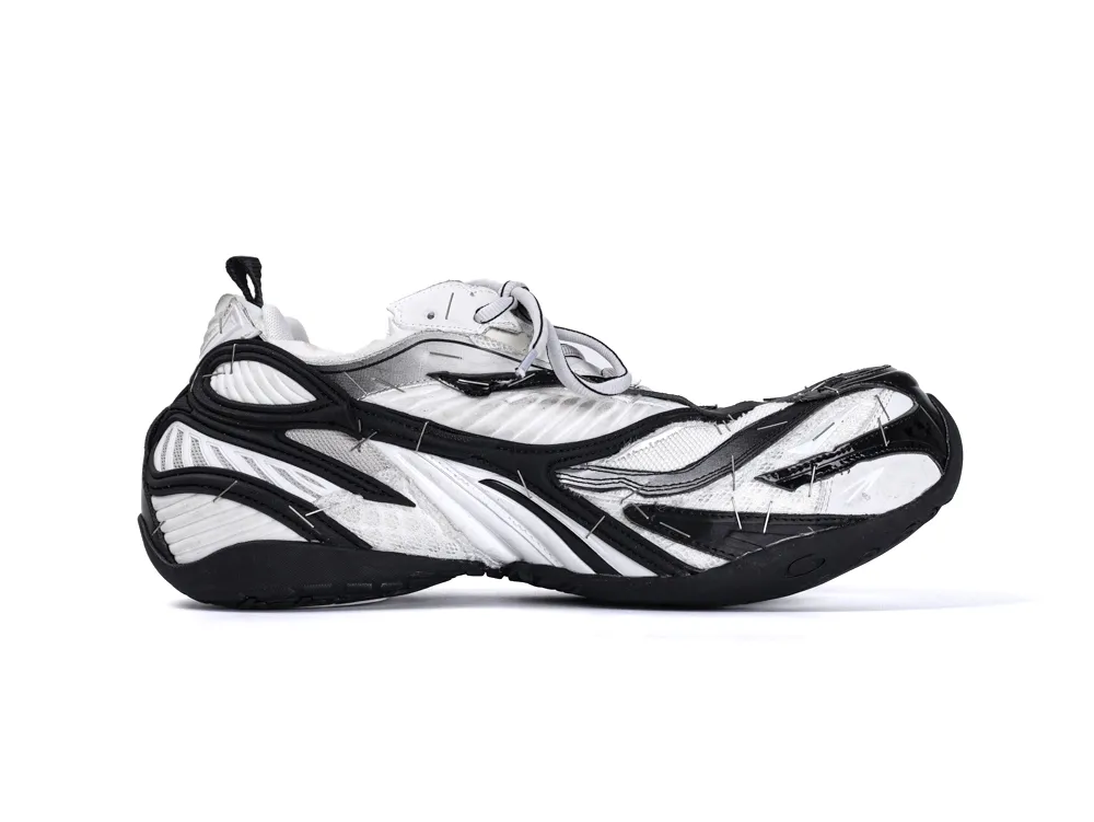 Black and white sneaker with a unique layered design and mixed materials.