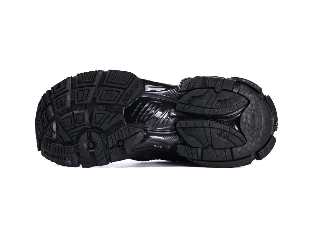 Black rubber sneaker sole with textured grip pattern and embossed branding details.