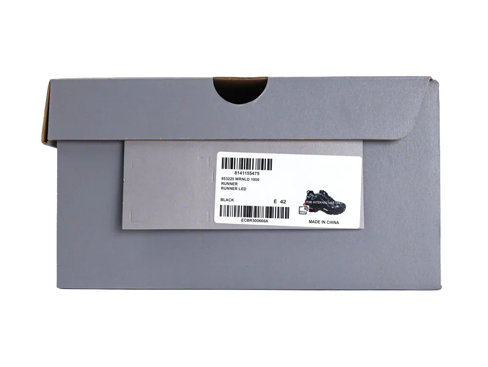 Gray cardboard shoe box with a white label showing a black shoe graphic.