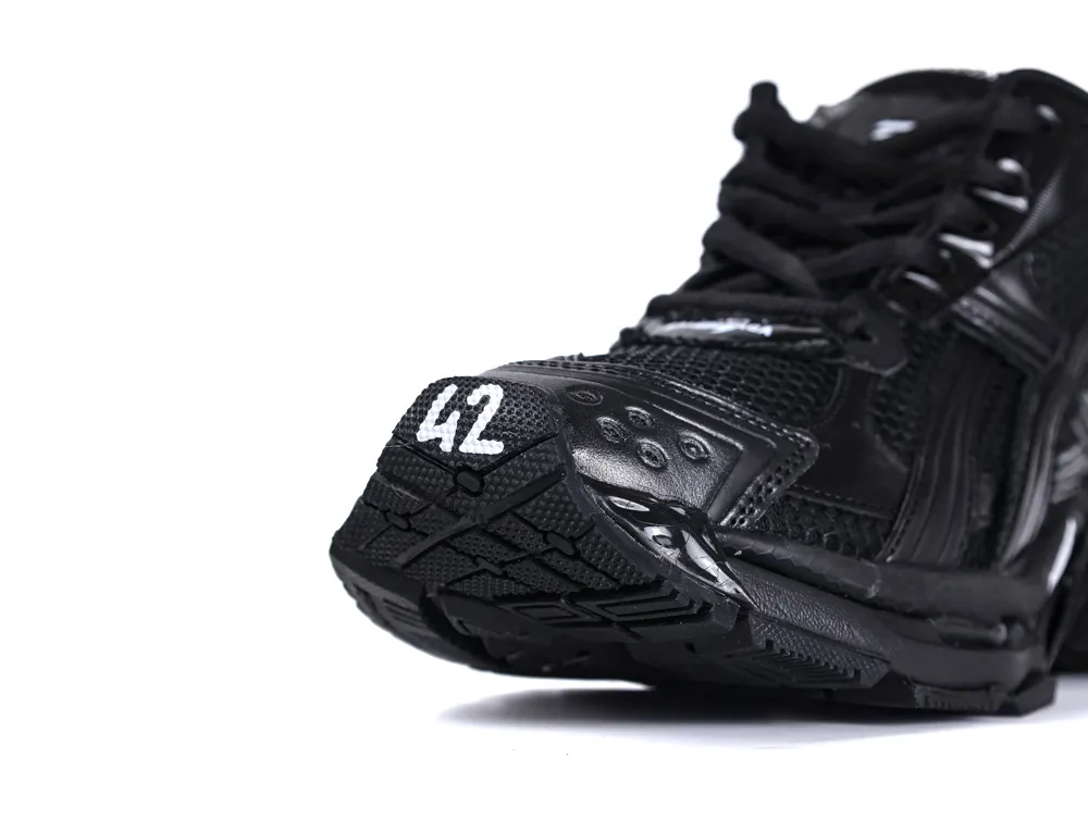 Black athletic shoe with mesh and leather details, featuring a rubber sole and toe.