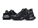 Black leather sneakers with mesh detailing and textured sole, featuring dynamic design elements.