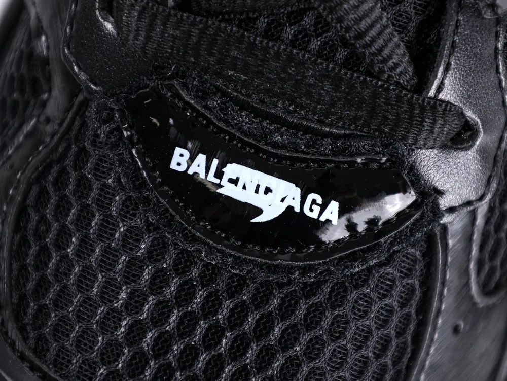 Black mesh and leather sneaker detail with logo on glossy panel.