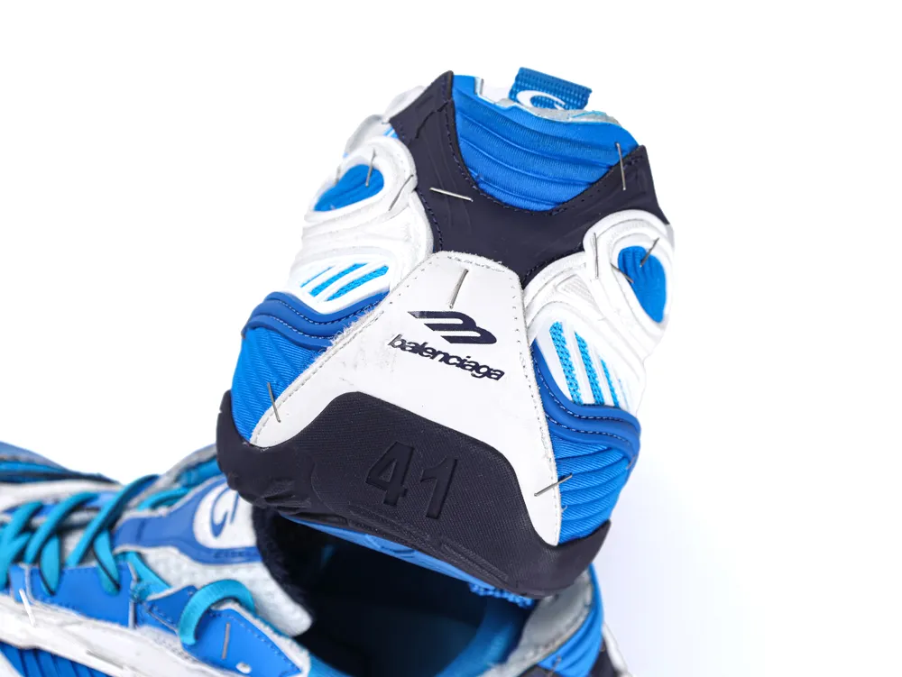 Blue and white athletic shoe, leather and mesh material, features rubber sole.