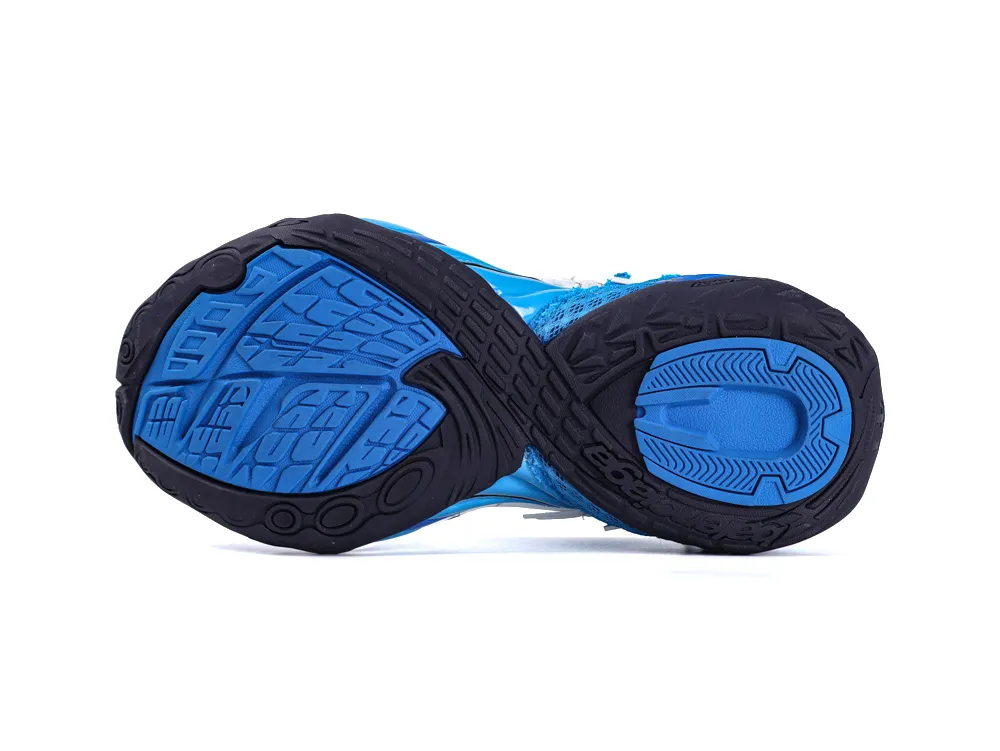 Blue and black rubber shoe sole with textured tread pattern for traction.