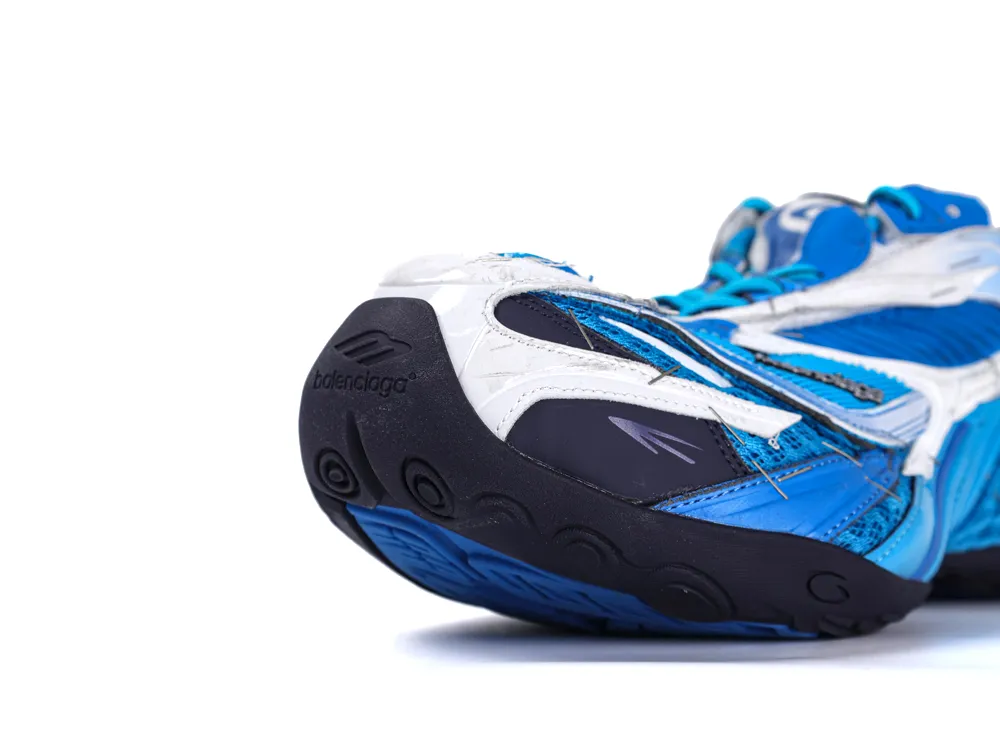 Close-up of blue and white sneaker with rubber sole, featuring modern design elements.
