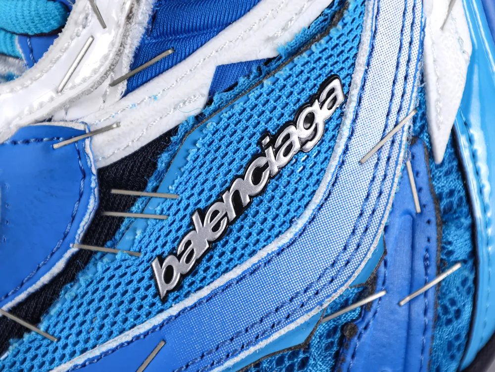 Close-up of a blue and white mesh sneaker with brand logo details.