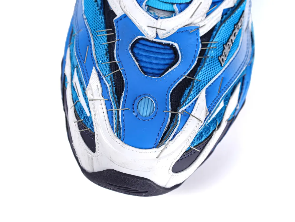 Blue and white sneaker toe with mesh and leather materials, close-up view.