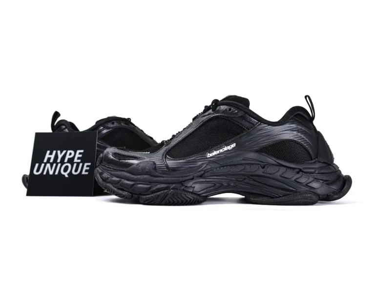Black sneakers with mesh and synthetic upper, featuring a chunky textured sole.