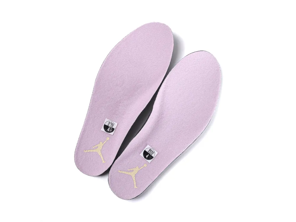 Pink fabric shoe insoles with black soles and a gold logo.