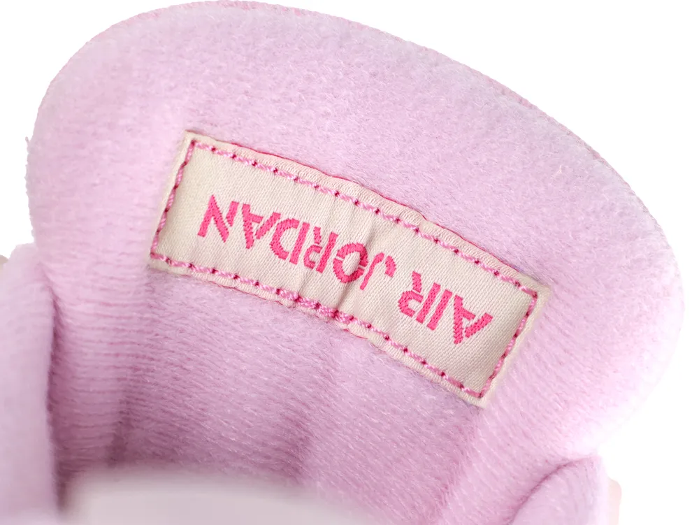 Pink fabric shoe tongue with "Air Jordan" stitched in vibrant pink thread.