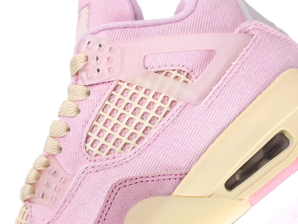 Close-up of a pink textile sneaker with beige mesh and rubber sole.