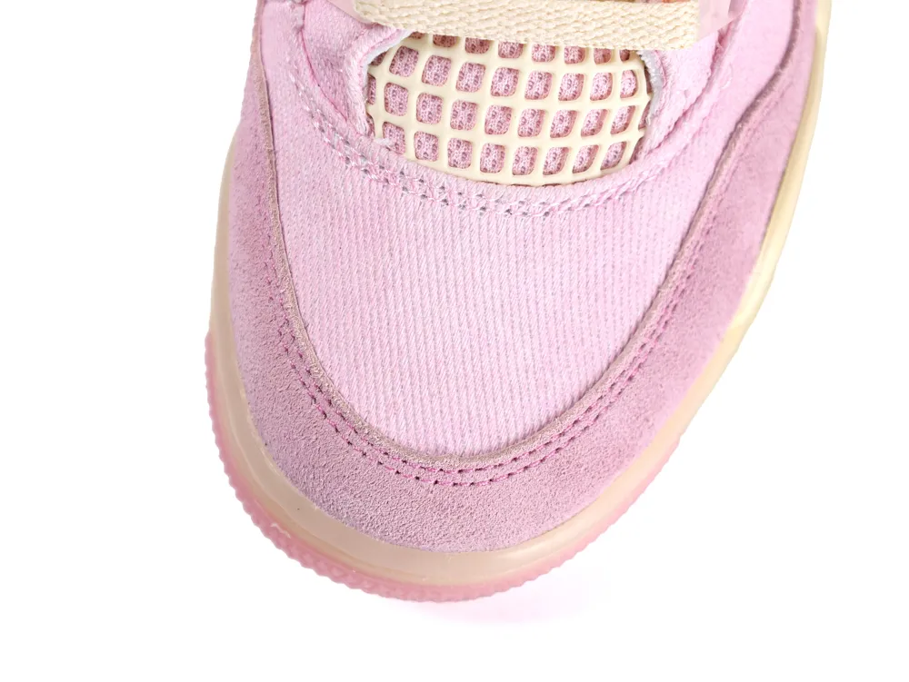 Close-up of a pink suede sneaker showing mesh and fabric details.