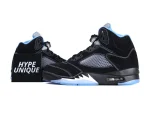 Black and blue suede sneakers with mesh side panels and translucent soles.