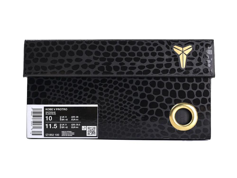 Black patterned shoe box with gold accents and circular detail, cardboard material.