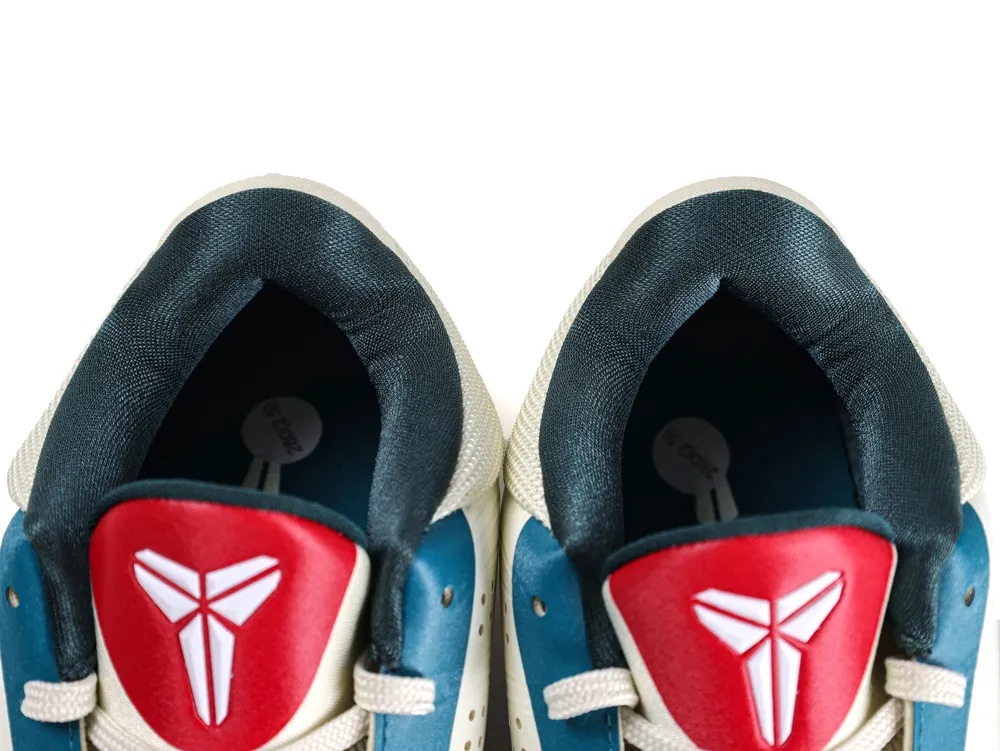 Blue, red, and white leather sneakers featuring a padded black interior and laces.