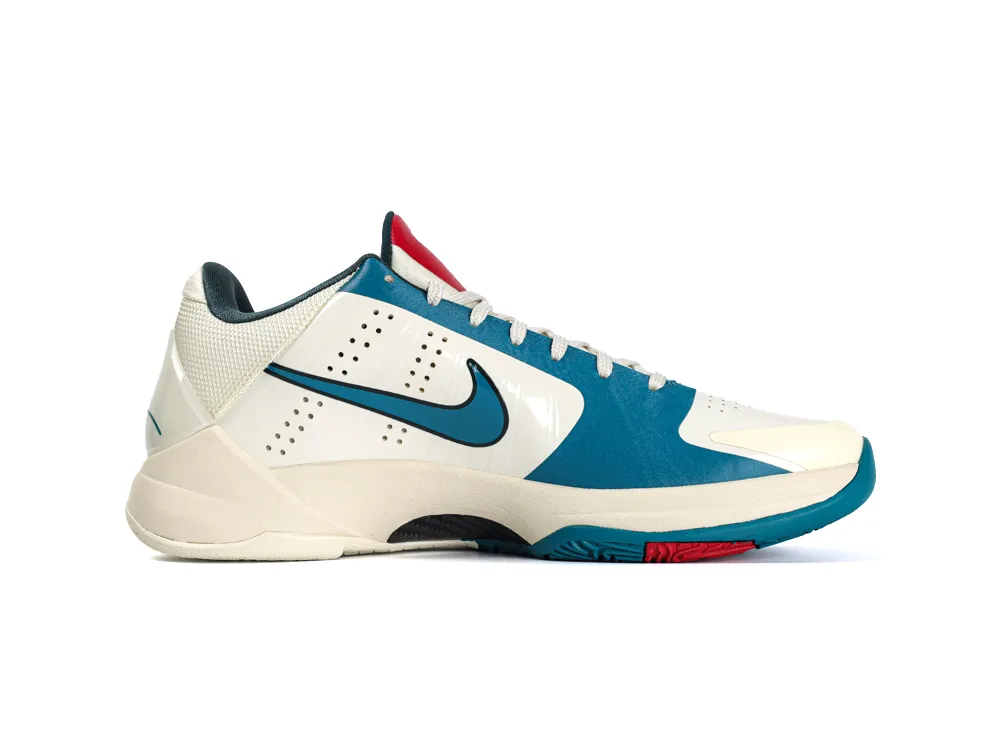 Cream and teal sneaker with mesh and synthetic upper, rubber sole, and red accent.