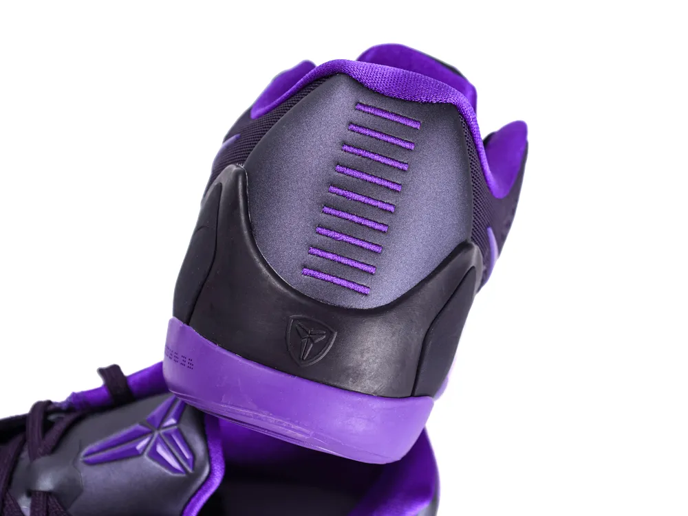 Purple and black sneaker with synthetic upper and textured heel design.