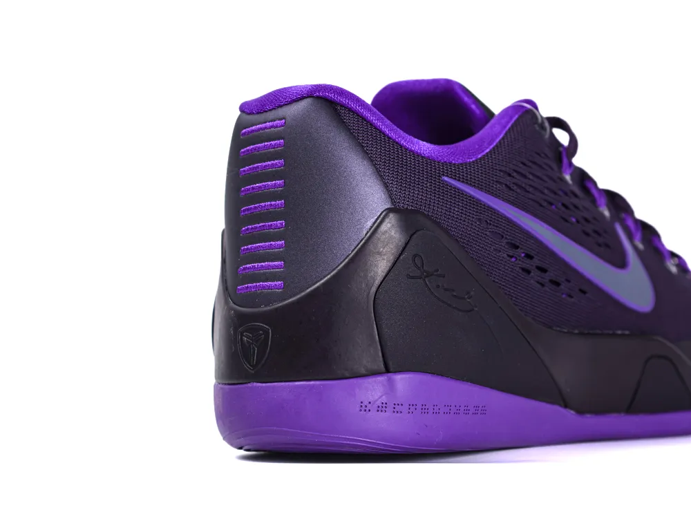 Purple and black sneaker with mesh material and rubber sole, featuring a swoosh design.