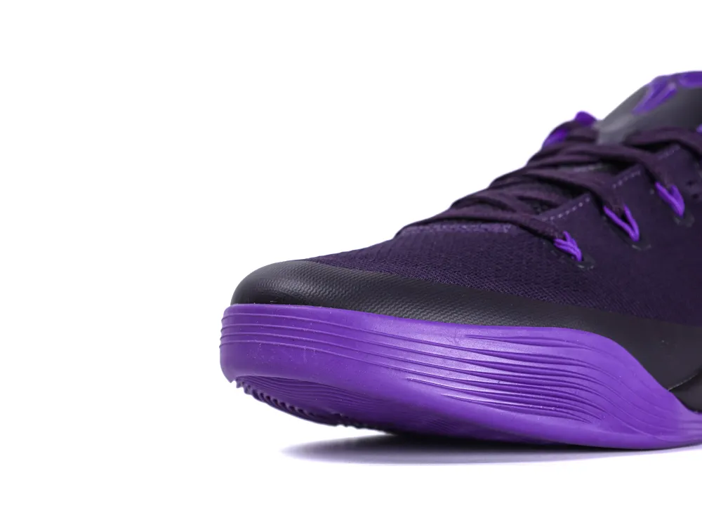 Close-up of purple synthetic sneaker toe with black accents and textured sole.