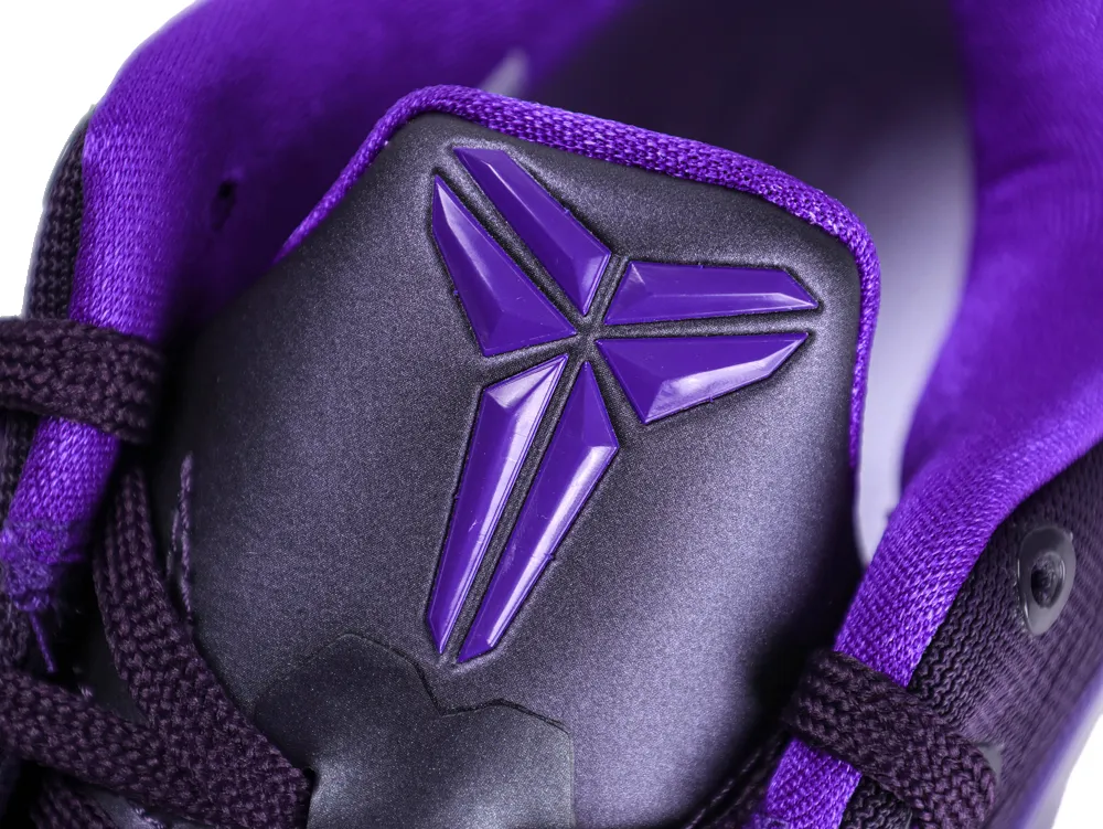 Close-up of a purple and black sneaker tongue with a textured material.