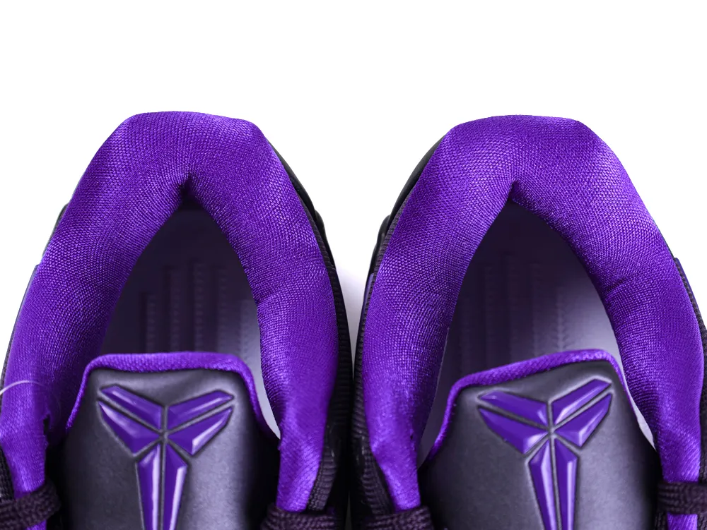 Purple fabric sneaker interiors with black accents and textured logo.