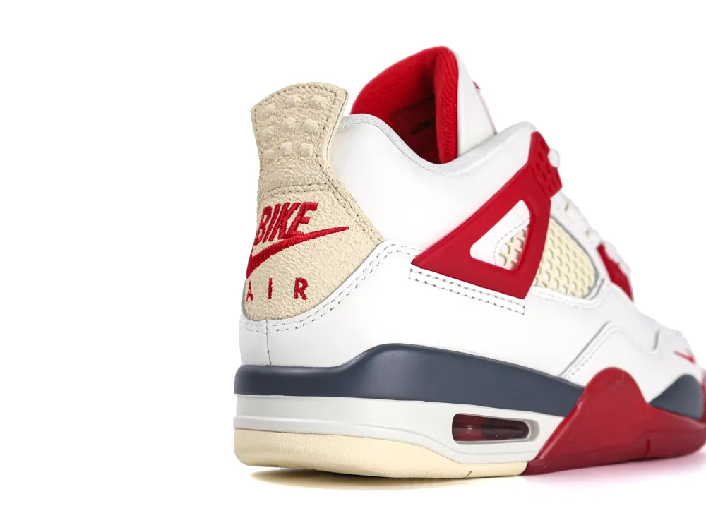 White and red sneaker with suede heel tab, mesh panels, and rubber sole.