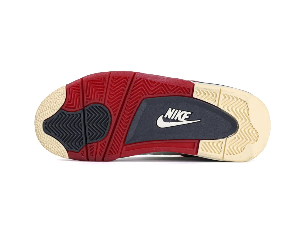 Red, black, and beige rubber sneaker sole with textured grip pattern.