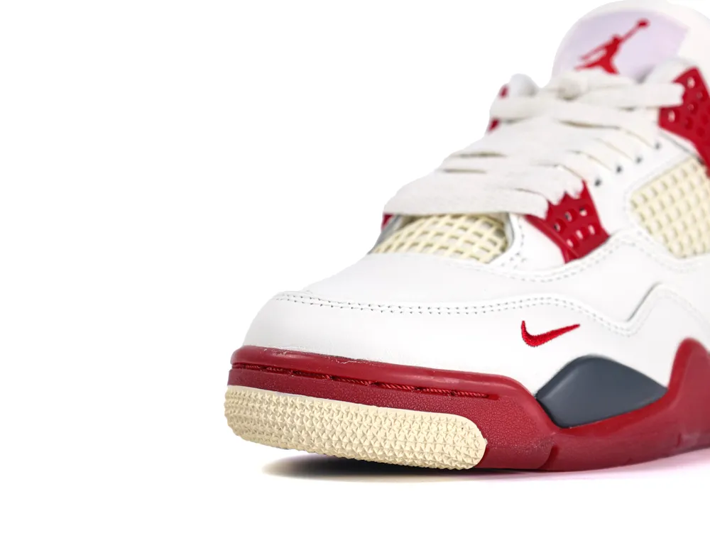 White and red sneaker with leather upper and mesh accents on the side.