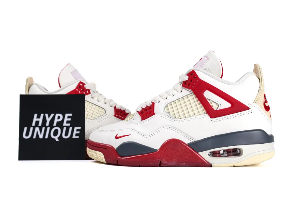 White and red leather sneakers with mesh paneling and rubber sole.