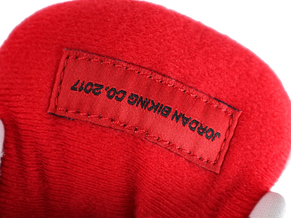 Close-up of red fabric tag with visible stitching.