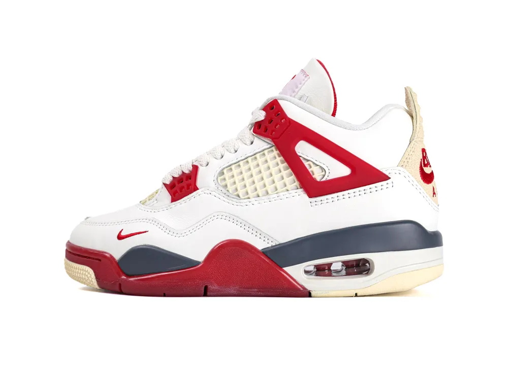 White and red sneaker with mesh and leather detailing, cushioned sole, and visible air unit.
